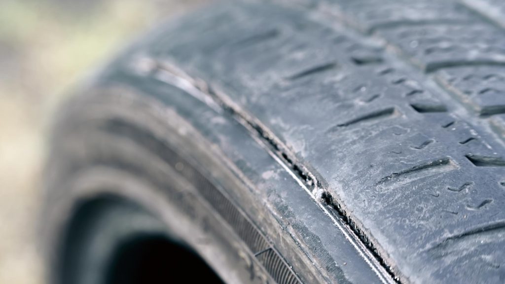 Close-up view of a car tire showing early signs of drying and surface cracks