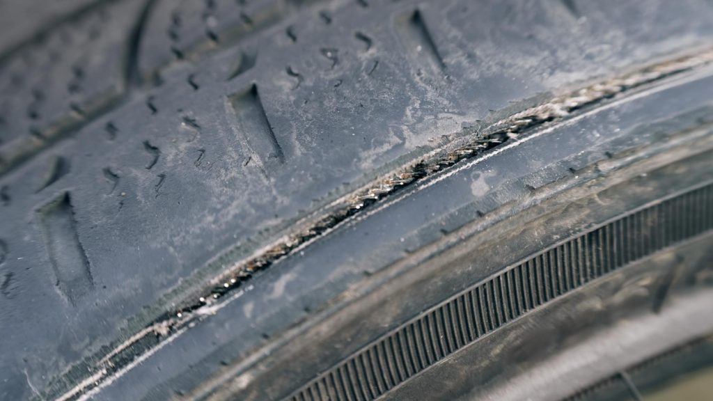 Tire tread with visible cracking caused by heat and prolonged sun exposure