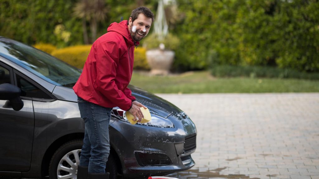 Driver washing car with soap