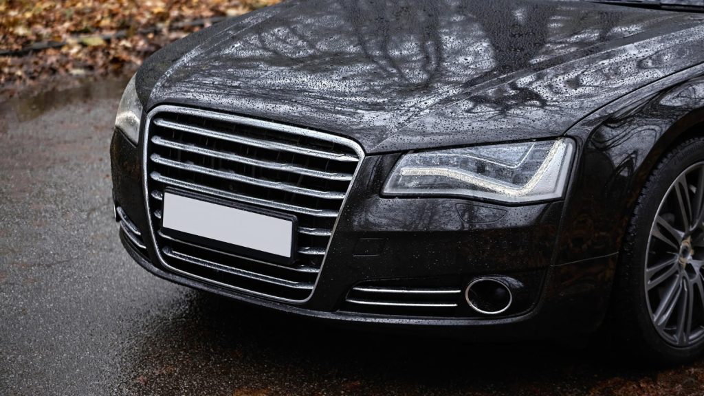 Dust visible on a black car before washing